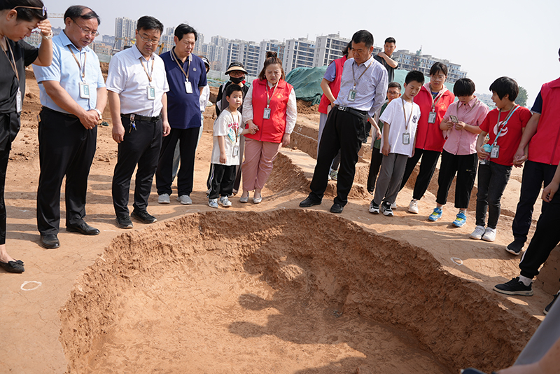 市考古院考古研究所副所长申文喜讲解半地穴遗址.JPG
